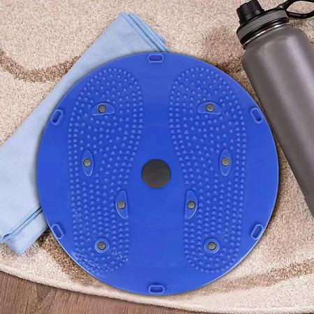 Blue massage pad with a towel and water bottle on a carpeted floor